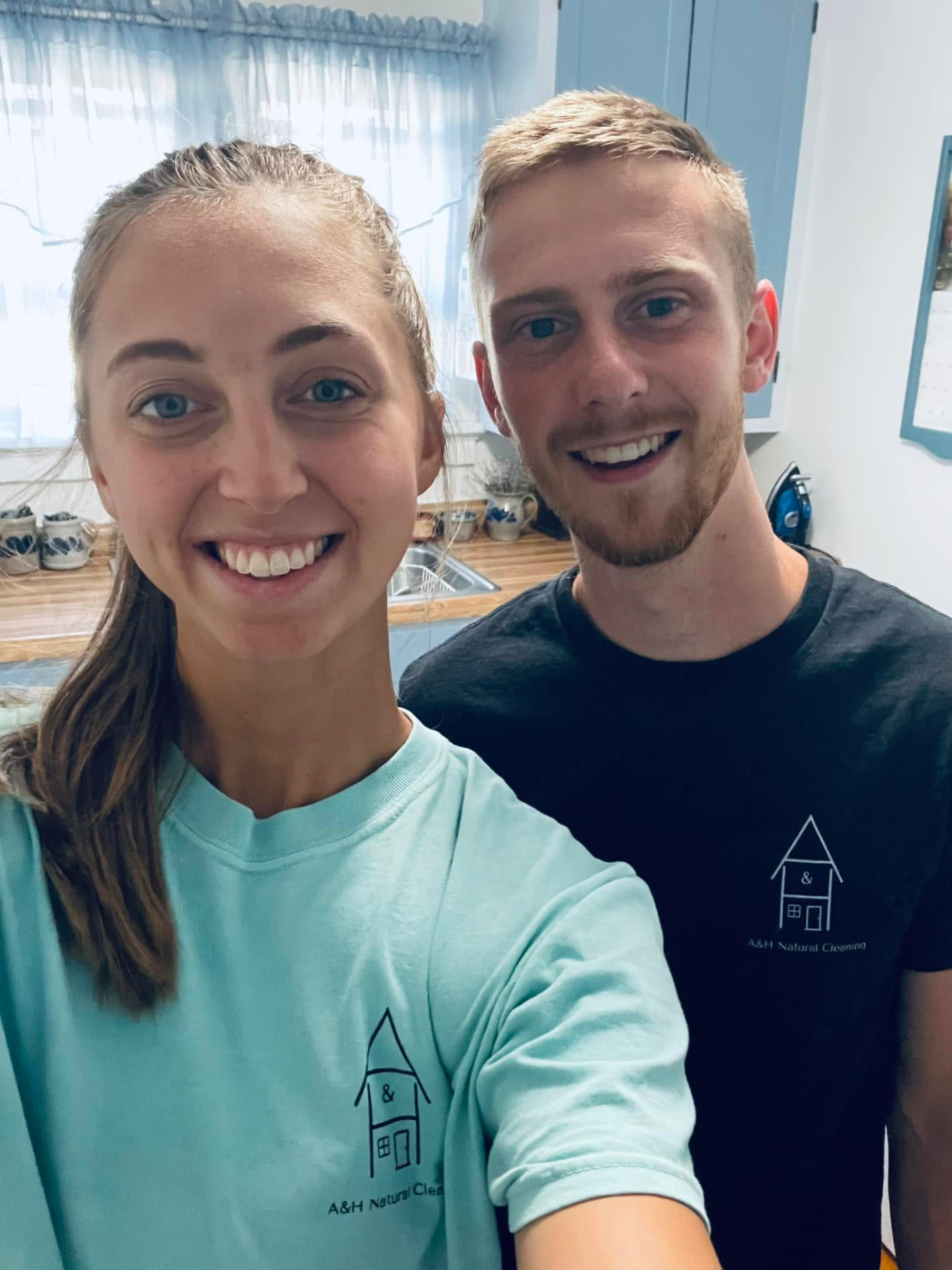 The A & H Natural Cleaning team smiling together in a bright kitchen